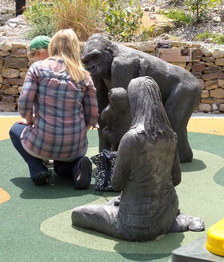 Statue of ape, woman and child, with real woman and child. Taronga. Photo R. Ashdown.