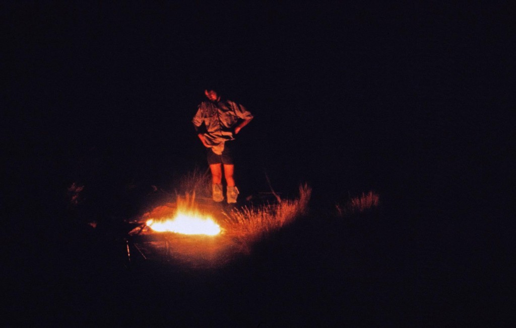 QM photographer Jeff Wright looks after the campfire in dry creek bed.