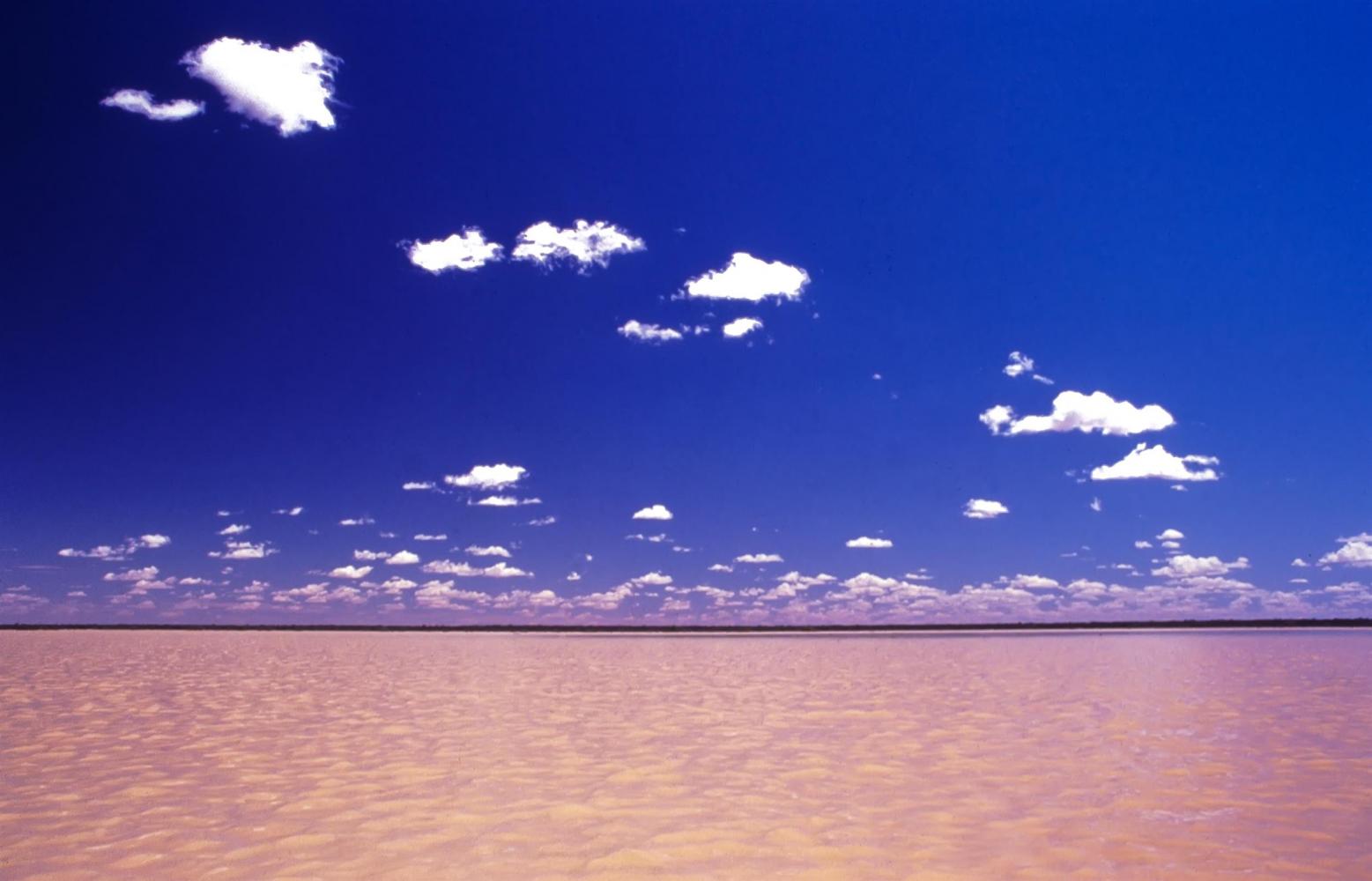 Back at water level, distant stranded dunes take on the appearance of strange islands.